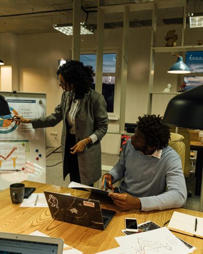 Professionals engaged in discussing data analysis during an office meeting.